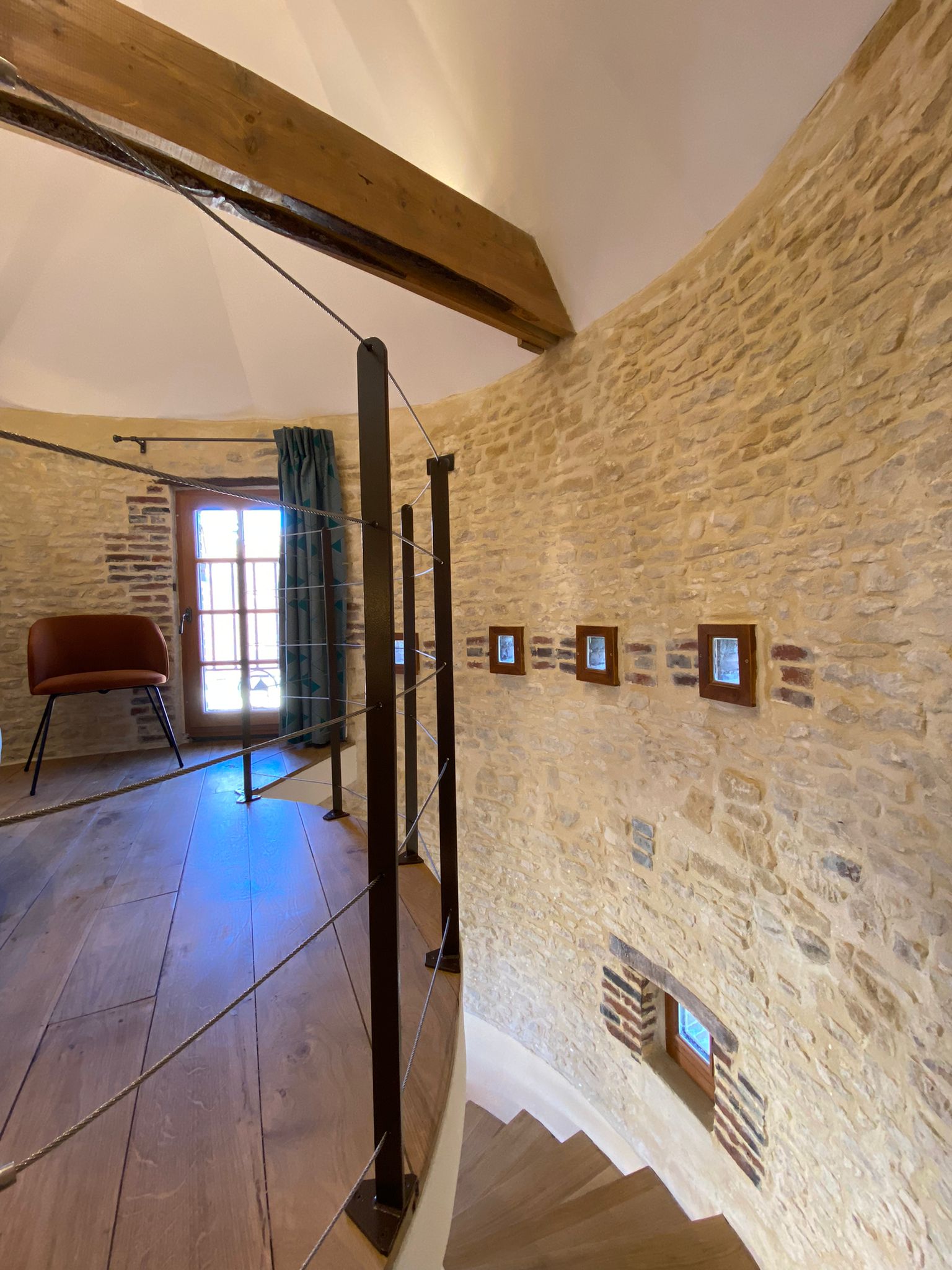 Domaine de Prestal rénovation ancien pigeonnier, escalier chambre Réhabilitation d'un ancien pigeonnier en chambre d'hôtes, détail escalier circulaire, petites fenêtres sur mesure en bois, garde-corps métalliques filaires, au Merlerault dans le perche normand