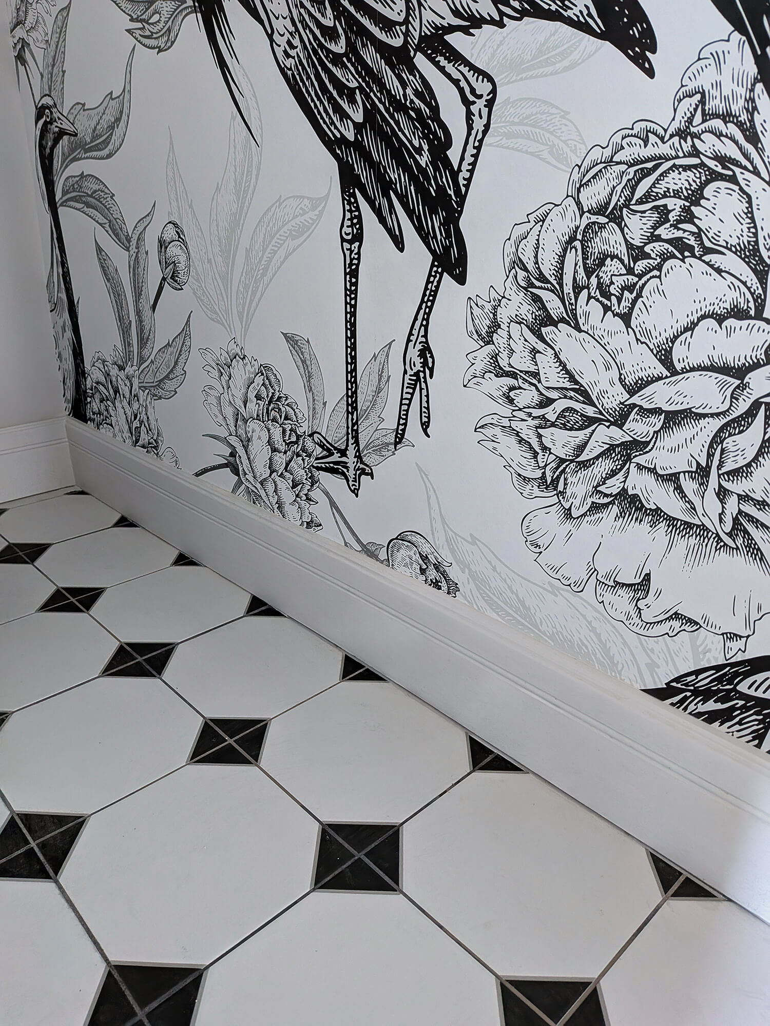Rénovation d’une maison meulière à Bonnières, retrouver le charme de l’ancien, toilettes avec sol cabochon et papier peint oiseaux noir et blanc